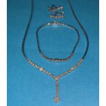 A modern white gold and diamond suite of necklace, bracelet and earrings, the necklace with