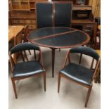 A 20th Century designer Scandinavian rosewood table and chairs, the table a circular extending
