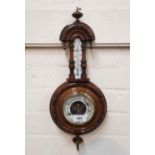 A late 19th century barometer/thermometer in banjo shaped case, 46 cm