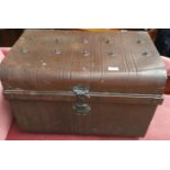 A metal cabin trunk painted brown