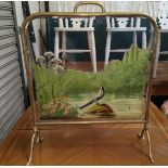 A Victorian brass firescreen with bevelled glass and painted river scene
