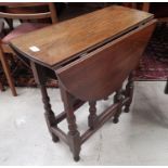 An 18th century oak small occasional table with oval top, on turned supports