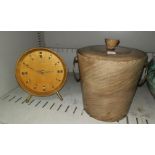 A 1960's Kienzle mantel clock in polished wood case; a polished wood ice bucket with brass