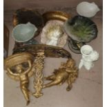 A selection of gilt wall shelves featuring cherub decoration