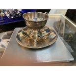 A silver cup and saucer and a small dish on 4 ball feet4.47oz