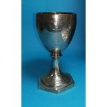 A Georgian silver goblet with chased decoration and presentation inscription, on hexagonal foot,