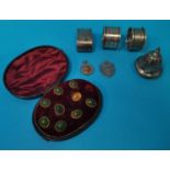 Three silver napkin rings; a sifter top; 2 fob medals