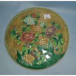 A Chinese famille jaune plaque decorated with flowers, with mark to back, 19cm diameter