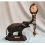 A 19th century French pendulum mystery clock with elephant support, stained wood oval plinth,