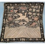 A Chinese silk embroidered square decorated with central bird, 29cm