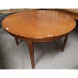 A 1960's teak dining suite comprising extending circular table and 4 chairs