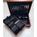 A 6 setting canteen of Alessi stainless steel cutlery in mahogany case
