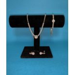 A modern white gold and diamond suite of necklace, bracelet and earrings, the necklace with