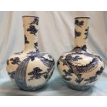 A Chinese pair of globular vases with underglaze blue decoration of dragons, 12" (one with