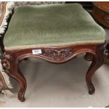 A carved walnut footstool with knurled legs