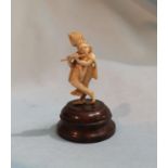 A late 19th / early 20th century carved ivory miniature Indian figure on base total height 6cm