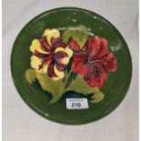 A Moorcroft green ground dish decorated with hibiscus, signed and impressed, diameter 8.5"