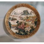 A Chinese Republic shallow dish decorated in polychrome with buildings in river landscape, famille