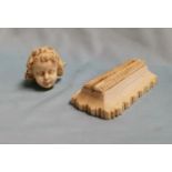 A 19th Century carved ivory menu stand and a carved cherub head (af)