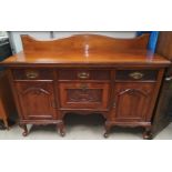 An Edwardian walnut sideboard base with carved and blind fret decoration, 3 frieze drawers and 3