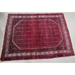 A 20th century Persian "Yahyali" rug, hand knotted, with red ground, narrow multiple border and