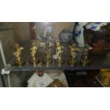 A miniature 6 piece musical band in the form of cast brass cherubs