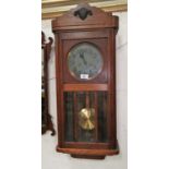 A 1930's oak cased wall clock with silvered dial, bevelled glass etc