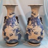 A Chinese pair of large crackle glaze vases decorated in blue with dragons, impressed seal to bases,