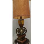 A large table lamp in the form of a vintage coffee grinder with coffee beans