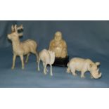 Late 19th / early 20th century a carved ivory figure of a Rhino, a figure of a stag
