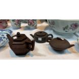 Three Chinese 'Yixing' terracotta teapots with impressed seal marks to bases, lengths 7", 2 x 6"
