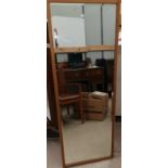 A rectangular oak framed bevel edge wall mirror