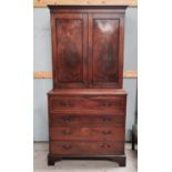 A George III mahogany secretaire/cabinet, the upper section with twin figured panelled doors, the