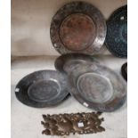 Four Turkish tinned copper dishes and a brass plaque
