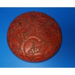 A Chinese red cinnabar lacquer circular lidded box decorated with flowers, diam 17cm