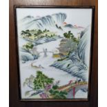 A Chinese porcelain polychrome plaque depicting river and figures in mountain landscape, in wooden