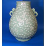 A large Chinese cermic celadon glazed vase with raised white floral decoration, ht 54cm, with