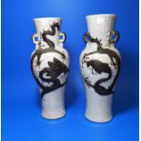 A pair of Chinese crackle glaze vases decorated with dragons in brown, marks to bases, ht 30cm (