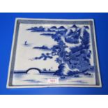 A Chinese porcelain blue and white rectangular tray with mountain landscape and sea decoration, 26cm