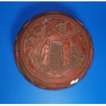 A Chinese red cinnabar lacquer circular lidded box decorated with monks (some cracking), diam 21cm