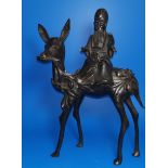 An oriental bronze depicting a sage riding on a deer (some damage, missing pieces, sage detachable)