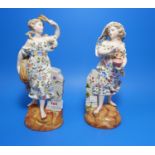 A pair of 19th century Dresden figures of young women decorated in polychrome, pne with vase, one