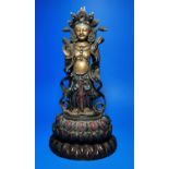 An oriental ceramic figure of Buddha decorated in gilt etc, on wooden stand