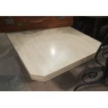 A white variegated marble coffee table, the rectangular top with canted corners, 47"