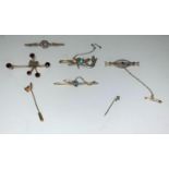 An Edwardian bar brooch set sapphire and seed pearls, stamped '15c'; a yellow metal bar brooch set