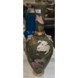 An early 20th century Japanese large satsuma vase decorated with flowers against a green ground,
