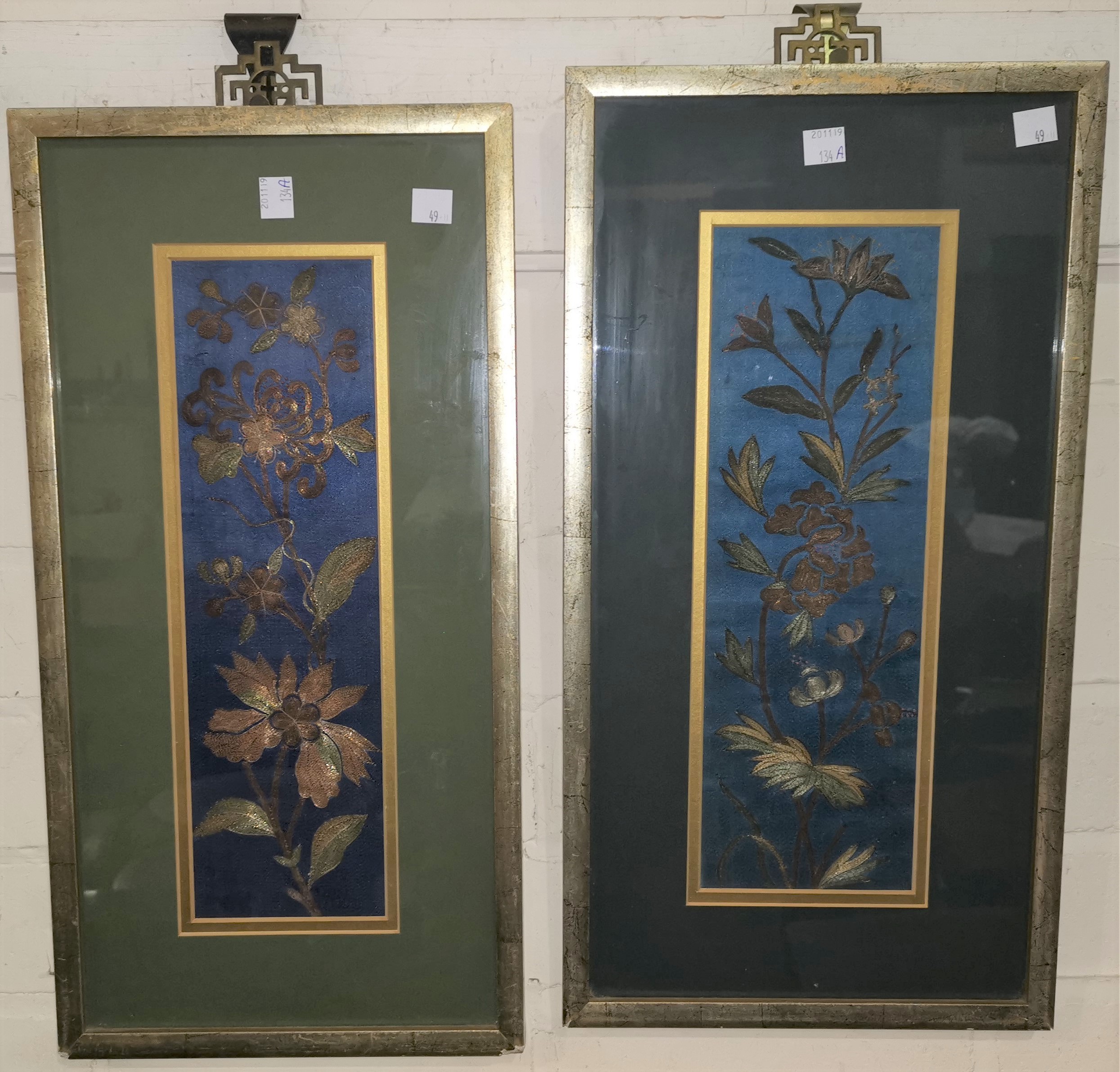 A Chinese pair of panels embroidered with gold and silvered metal thread in the form of flowering