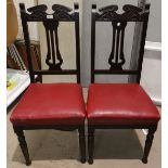 A set of 4 Edwardian dining chairs with leather effect seasts