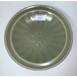 A Chinese Ming style early "Long Yuan" shallow dish, with ribbed bowl and central flower head under