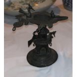 An antique Indian bronze oil lamp on pedestal base, 16 cm